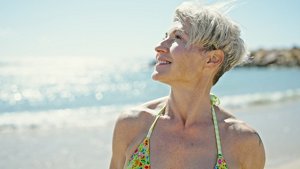 Older woman with a textured fringe haircut on the beach